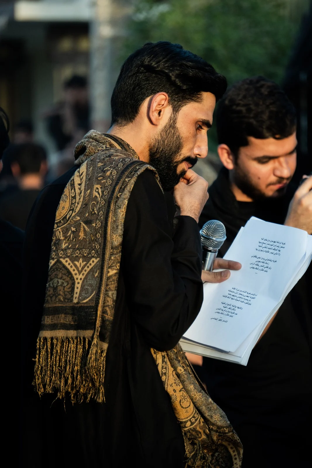 One man looking at a page beside another