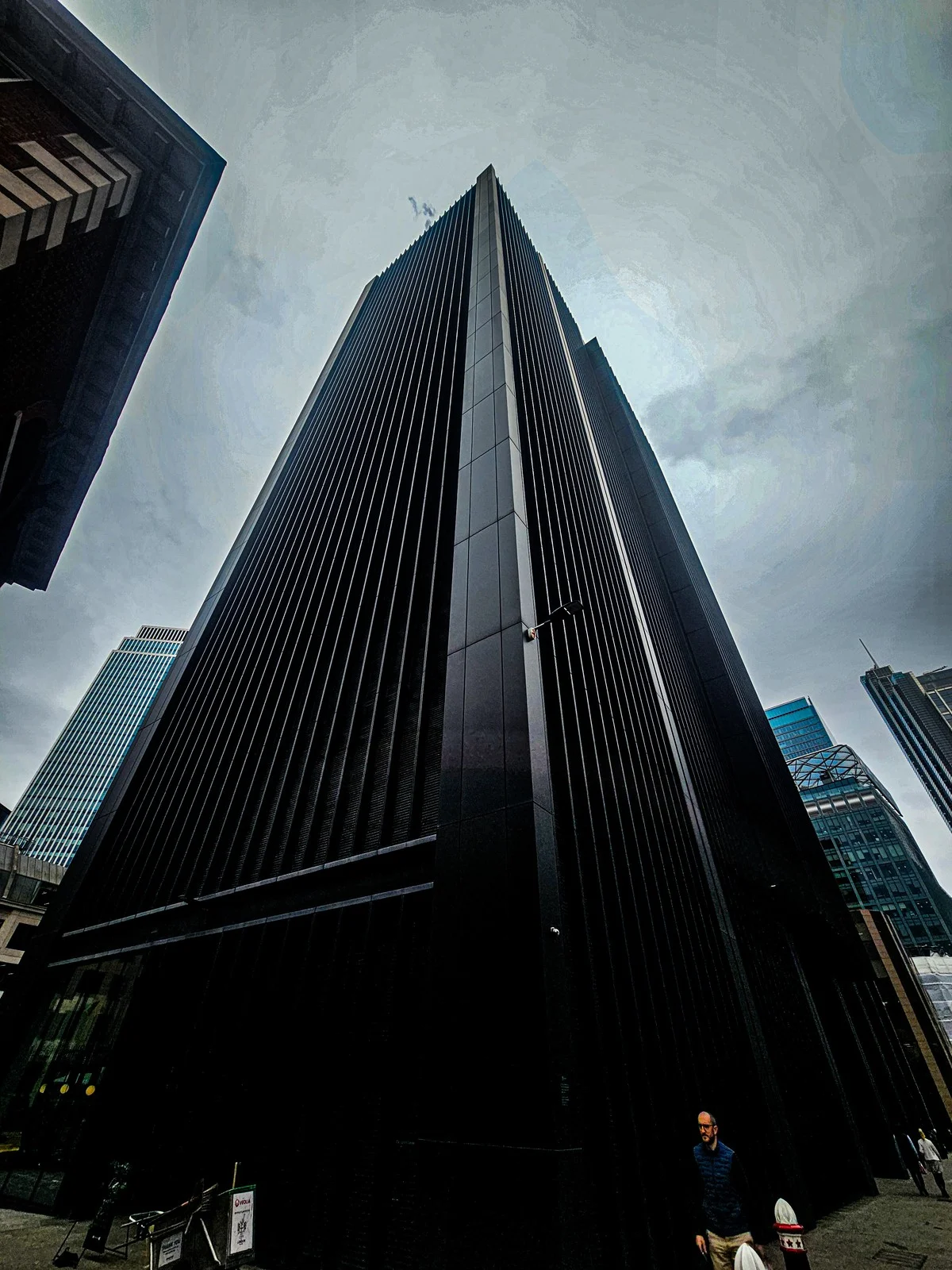 Dark tower beneath clouds